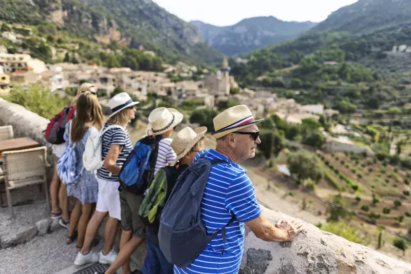 Multi generation family sightseeing beautiful town of Valldemossa, Majorca, Spain