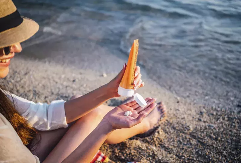 Woman using sunscreen