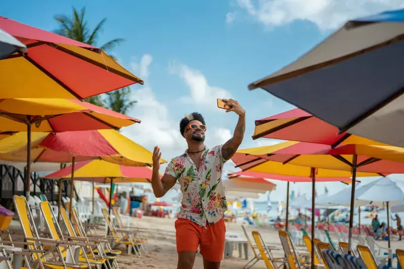 Man vlogging on the beach