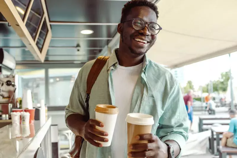 student picking up a coffee