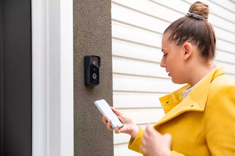 Woman using a phone to enter an office