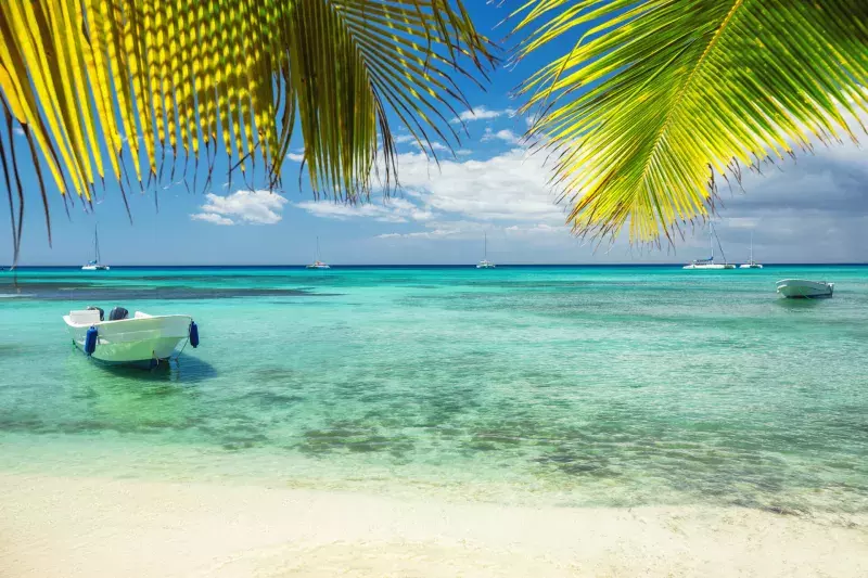 boat on the shore of exotic tropical island, panoramic view from the beach