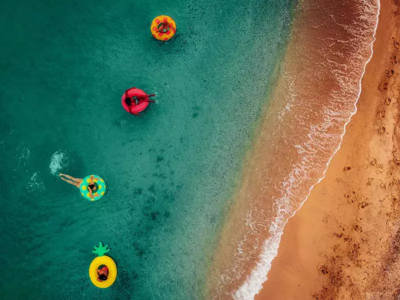 friends having fun on floaties in water